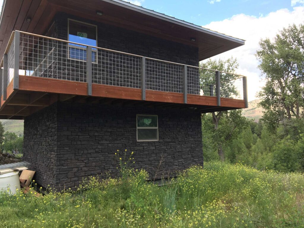 Full exterior stone veneer masonry on a high-end residential build.