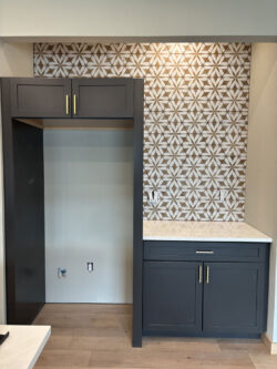 Artisan Kitchen Tile Custom geometric patterned tile backsplash in a modern dark-cabinet kitchen.