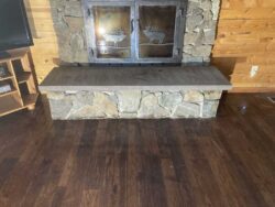 Hand-Dressed Hearth Hand-dressed interior stone fireplace hearth with iron doors.